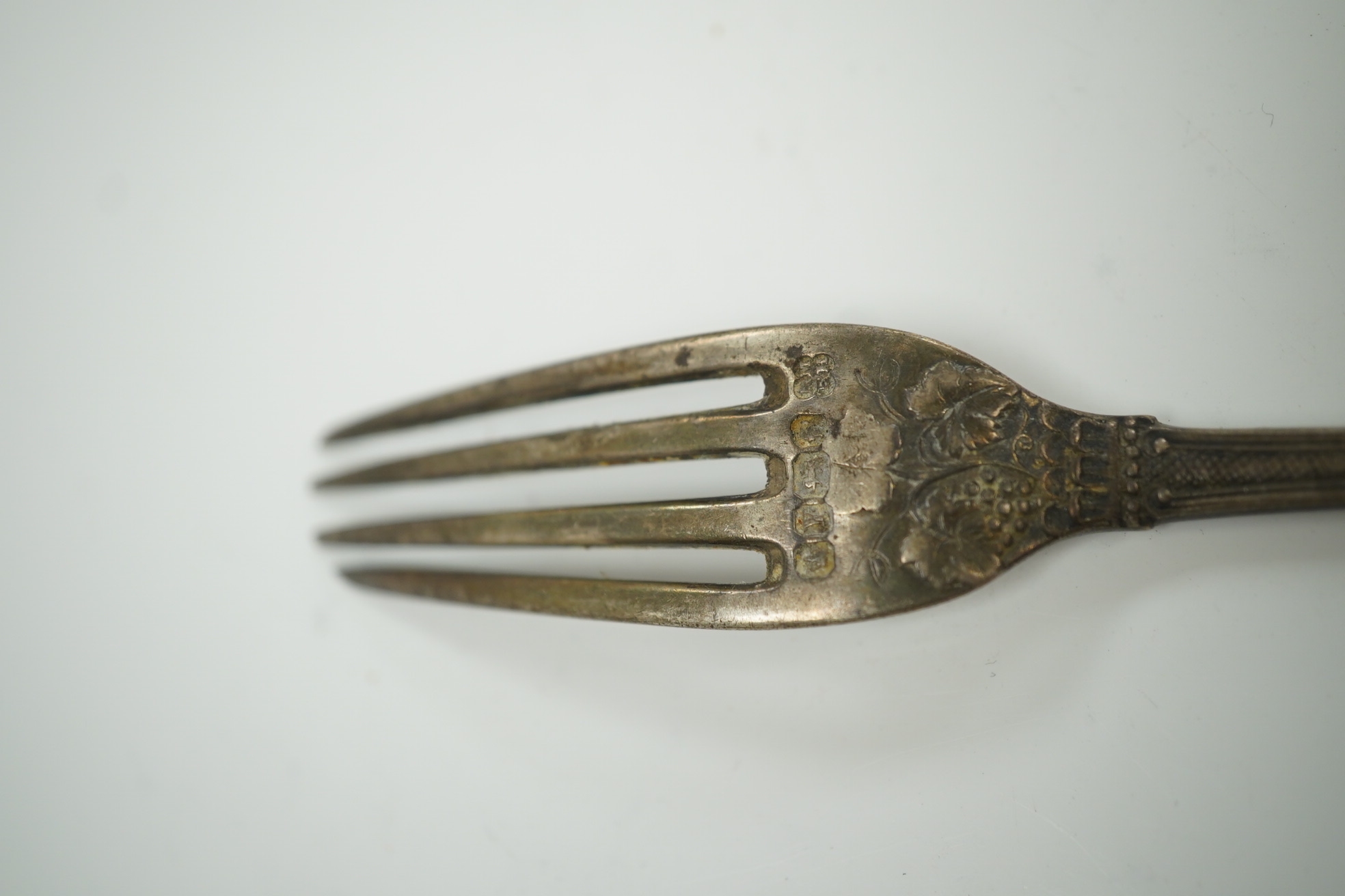 Twenty three items of mainly 19trh century silver fiddle pattern flatware, various dates and makers and a small group of assorted silver and white metal flatware, including Tiffany spoon, 39.8oz. Condition - poor to fair